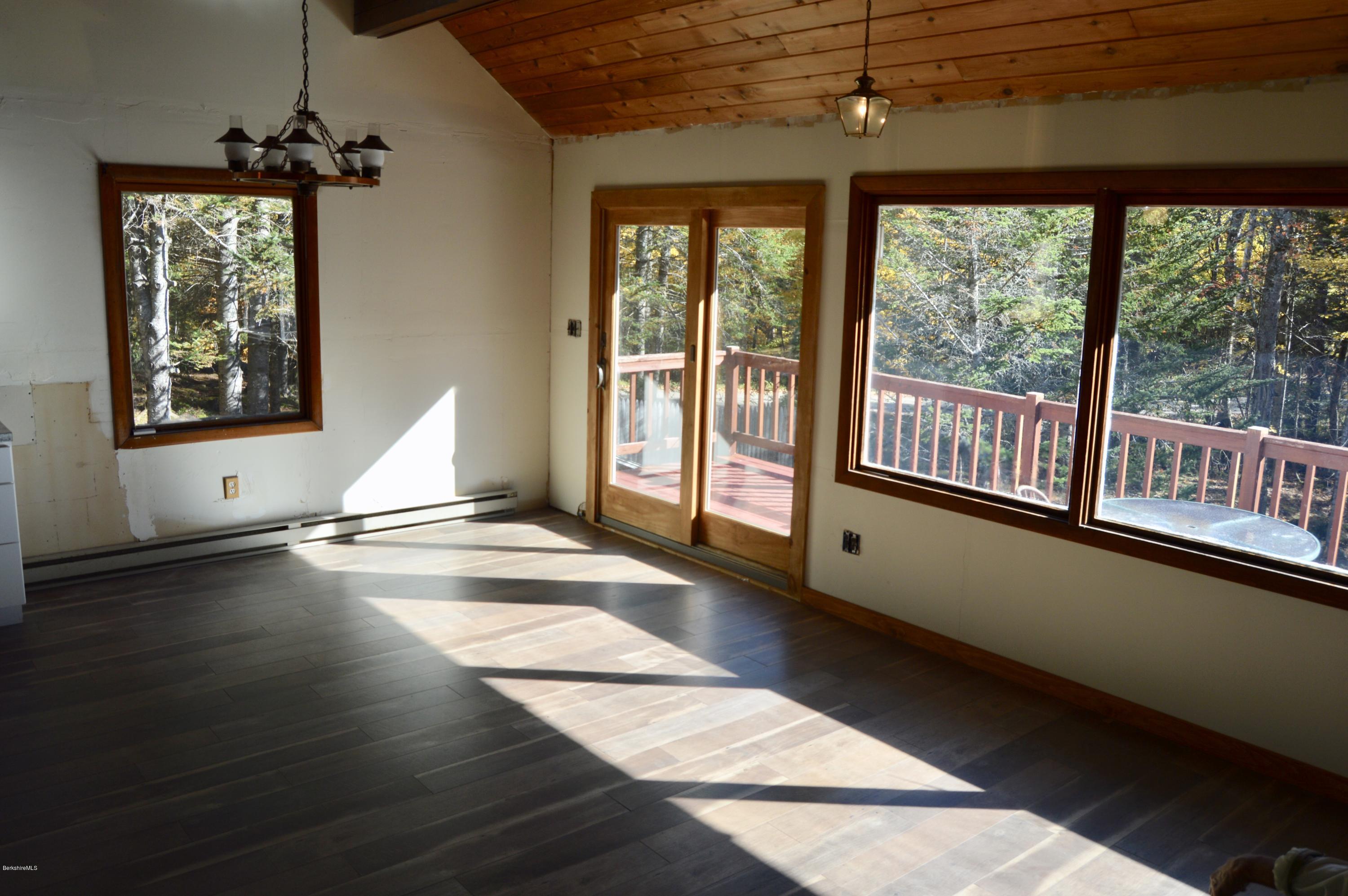 25 Davis Road Monroe, MA 01350 - Photo 12 of 27 a view of an empty room with wooden floor and a window