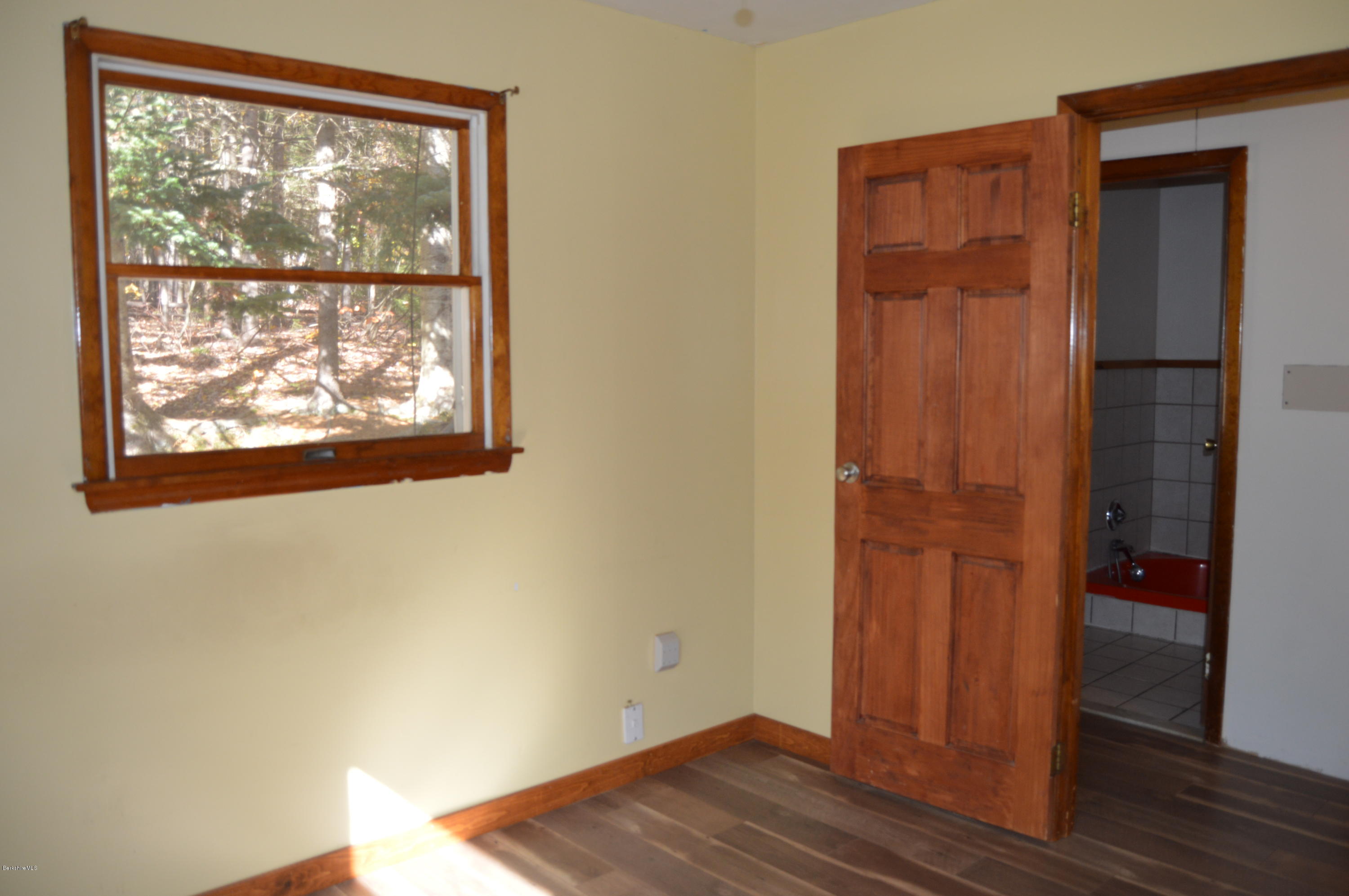 25 Davis Road Monroe, MA 01350 - Photo 13 of 27 an empty room with wooden floor closet and windows