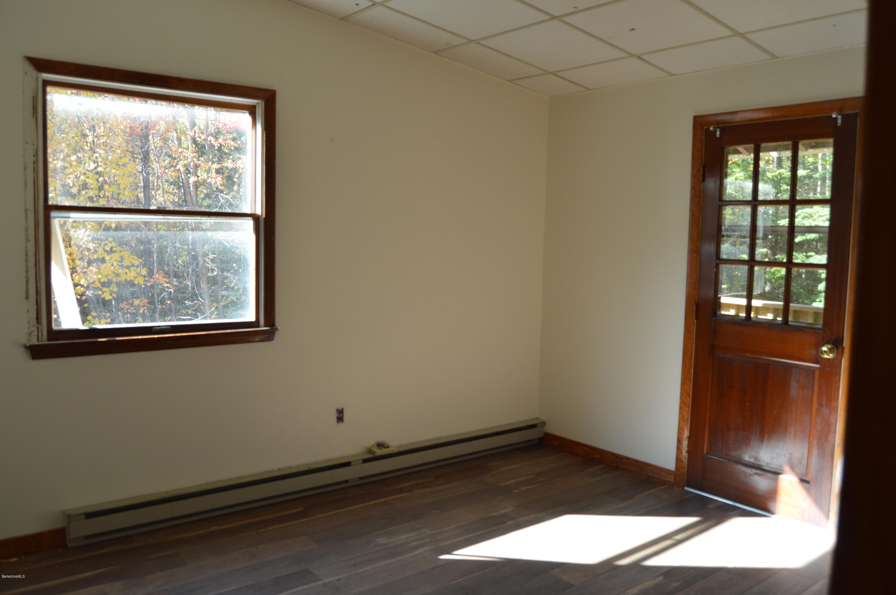 25 Davis Road Monroe, MA 01350 - Photo 18 of 27 an empty room with wooden floor and windows