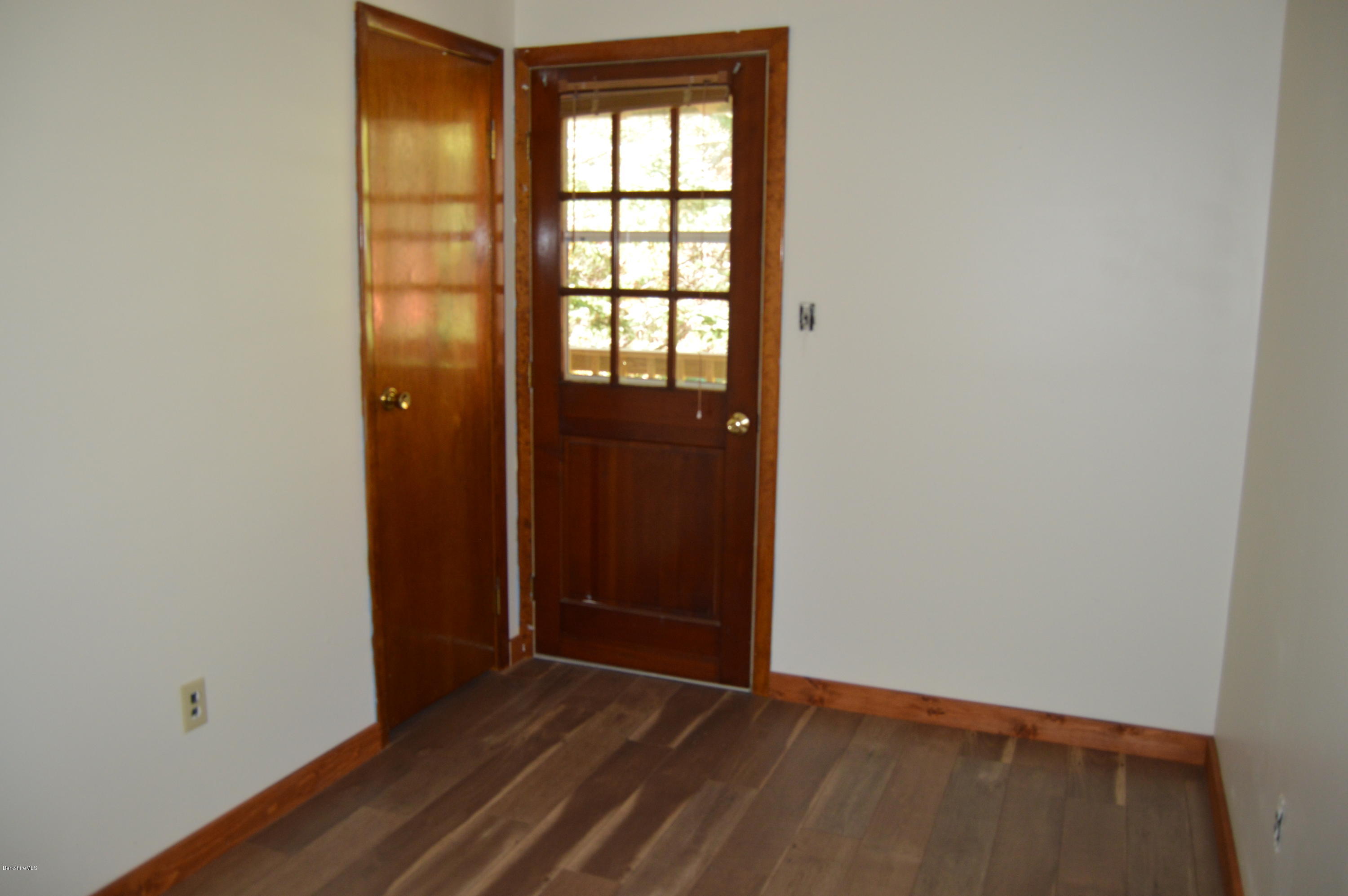 25 Davis Road Monroe, MA 01350 - Photo 19 of 27 a view of an empty room with wooden floor and a window