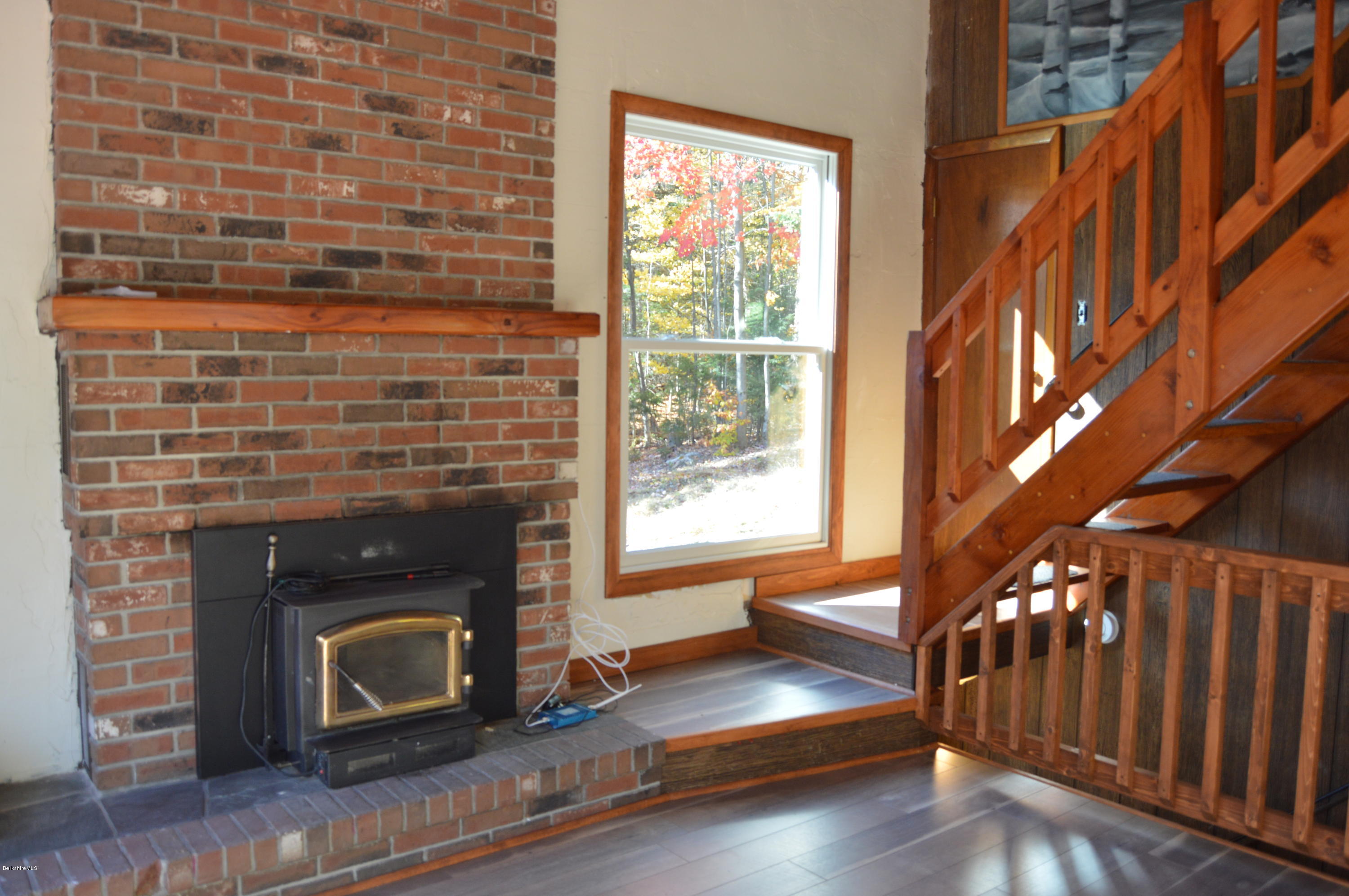 25 Davis Road Monroe, MA 01350 - Photo 8 of 27 a living room with a fireplace and a wooden floor