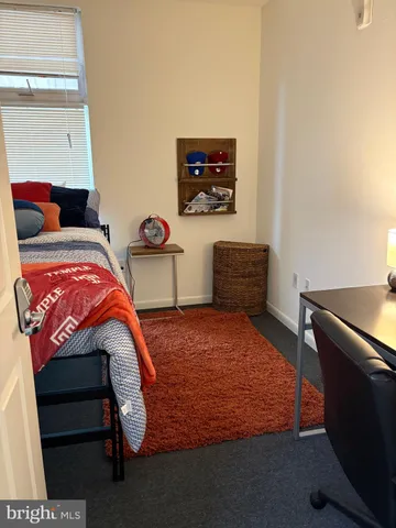 a bedroom with a bed and two windows