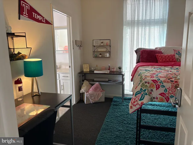 a bedroom with a bed and window