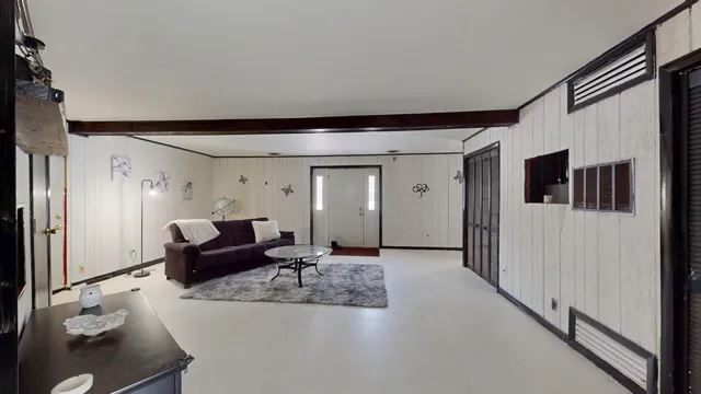 a view of staircase with lots of frames on wall and a large window