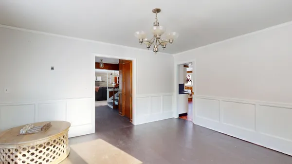 a living room with furniture and large windows