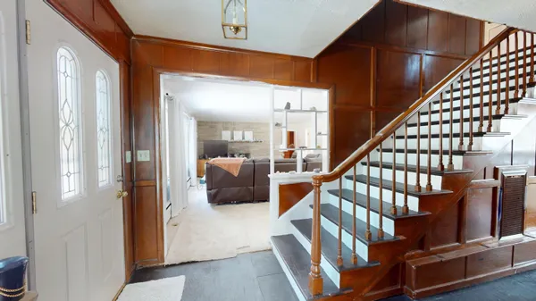 a kitchen with sink a refrigerator and chairs