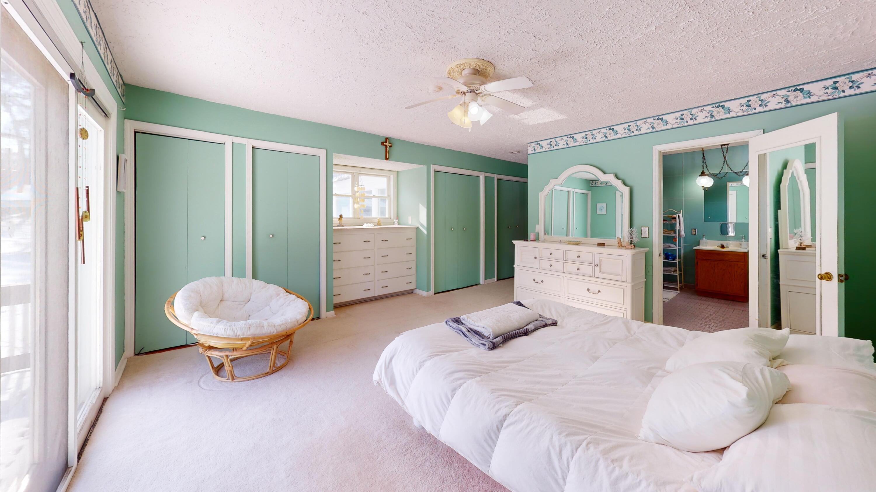 2240 South 350 East Knox, IN 46534 - Photo 43 of 103 a spacious bedroom with a bed and chandelier