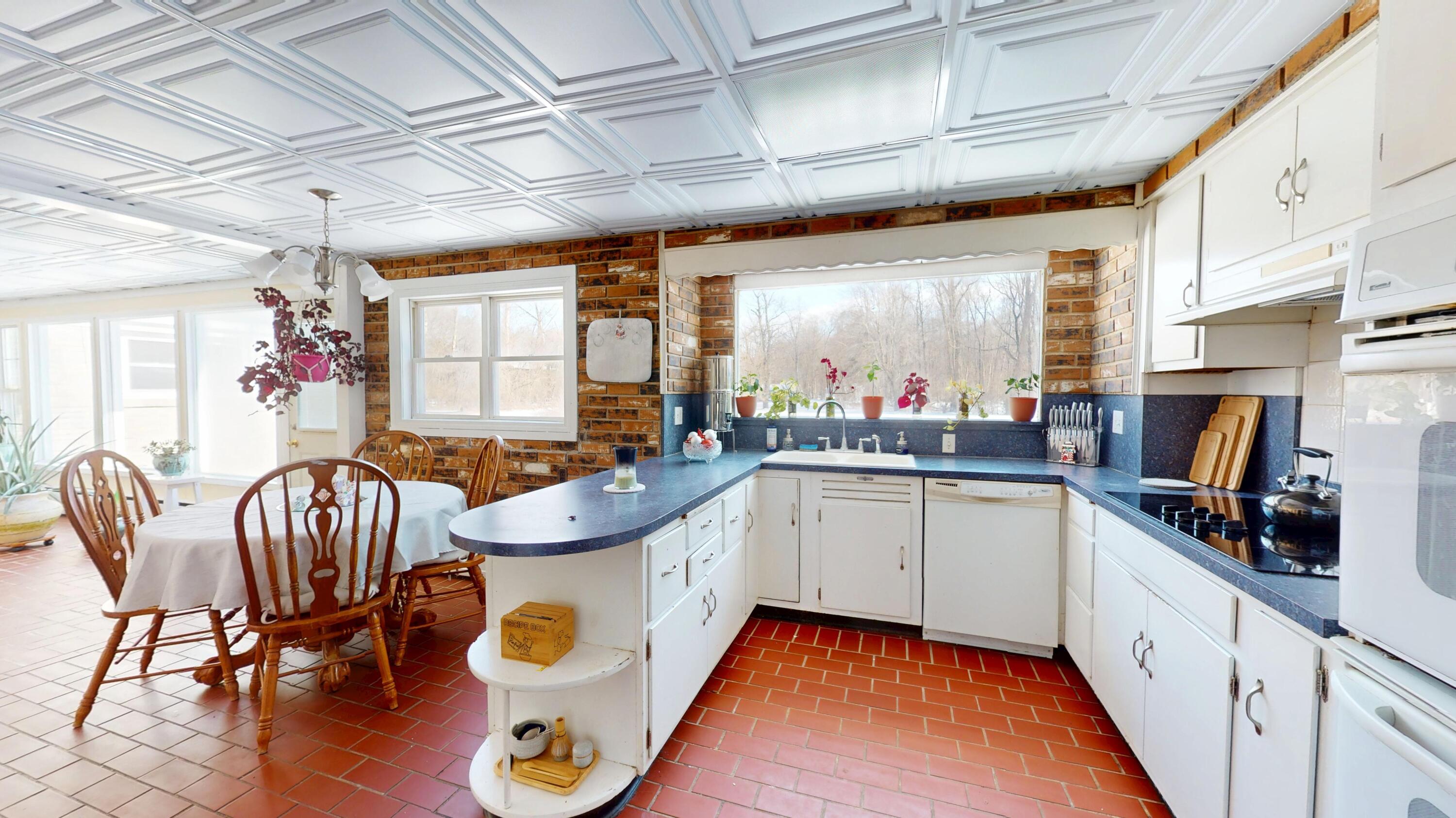 2240 South 350 East Knox, IN 46534 - Photo 60 of 103 a kitchen with sink a refrigerator and chairs