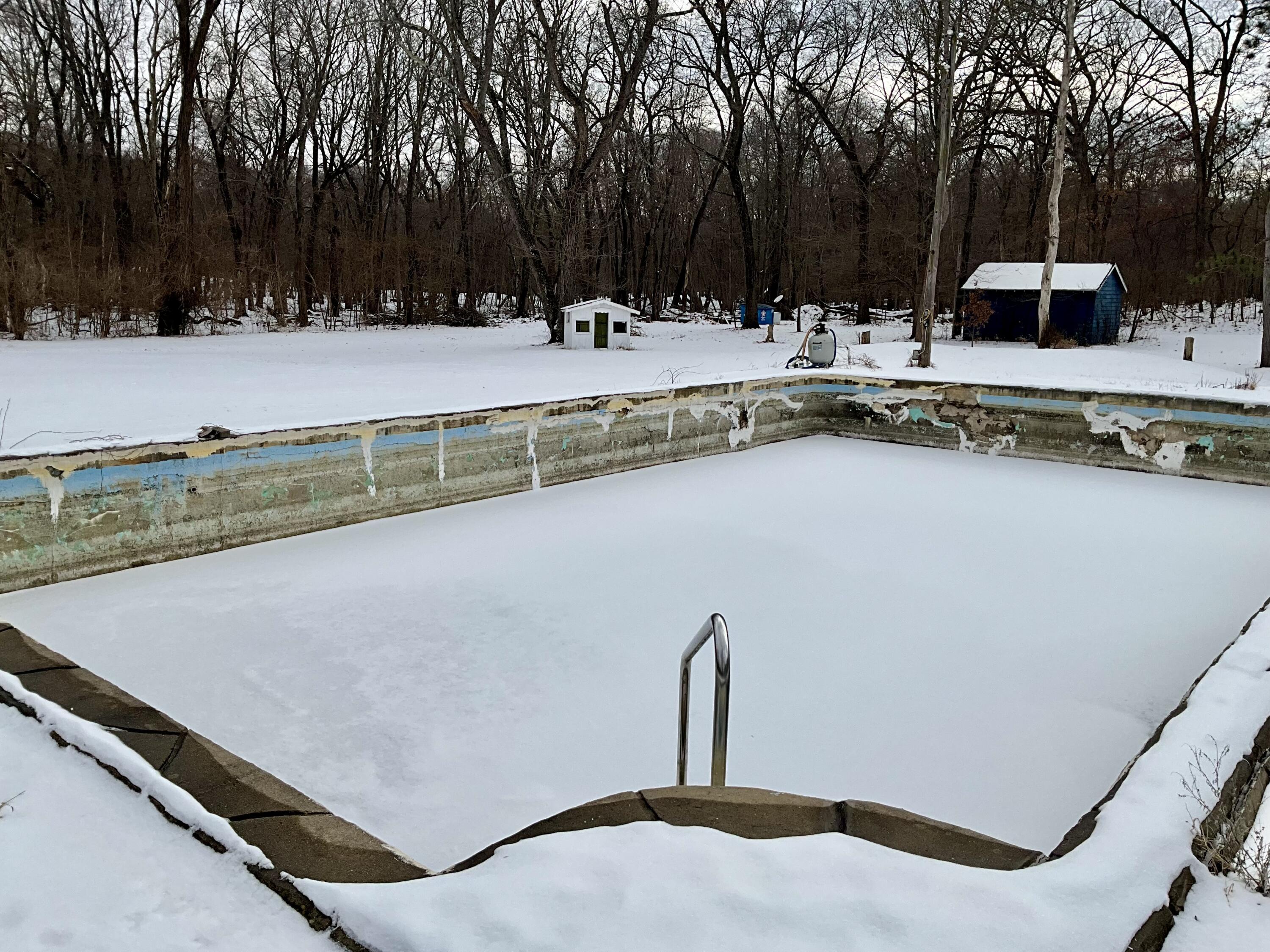 2240 South 350 East Knox, IN 46534 - Photo 98 of 103 a view of a swimming pool with a chair and trees