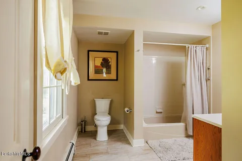 a bathroom with a toilet a sink and a bathtub