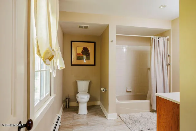 a bathroom with a toilet a sink and a bathtub
