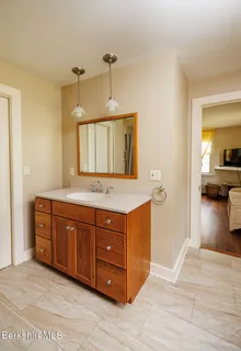 a spacious bathroom with a granite countertop double vanity sink and a mirror