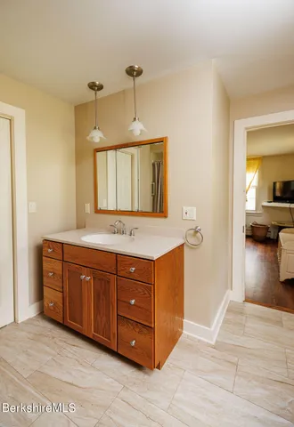 a spacious bathroom with a granite countertop double vanity sink and a mirror