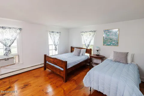 a bedroom with two beds and a window