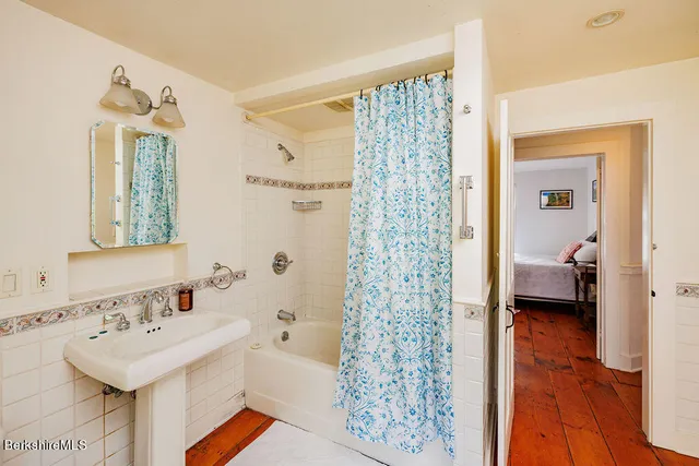 a en suite bathroom with a sink a mirror and a shower
