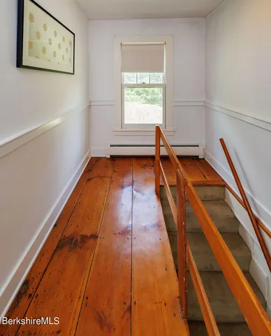 a view of a room with wooden floor and stairs
