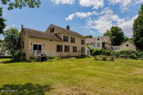 a front view of the house with yard and green space
