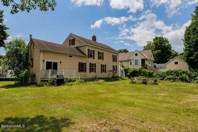 a front view of the house with yard and green space
