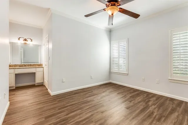 an empty room with windows and fireplace