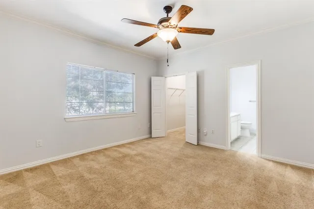 an empty room with fan and windows