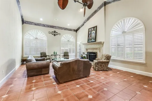 a living room with furniture a large window and a fireplace