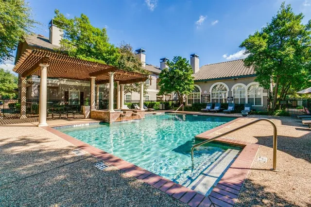a view of a house with swimming pool and sitting area
