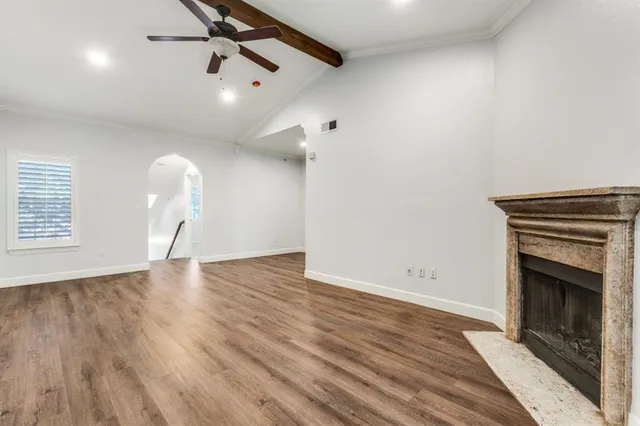 wooden floor in an empty room with a fireplace