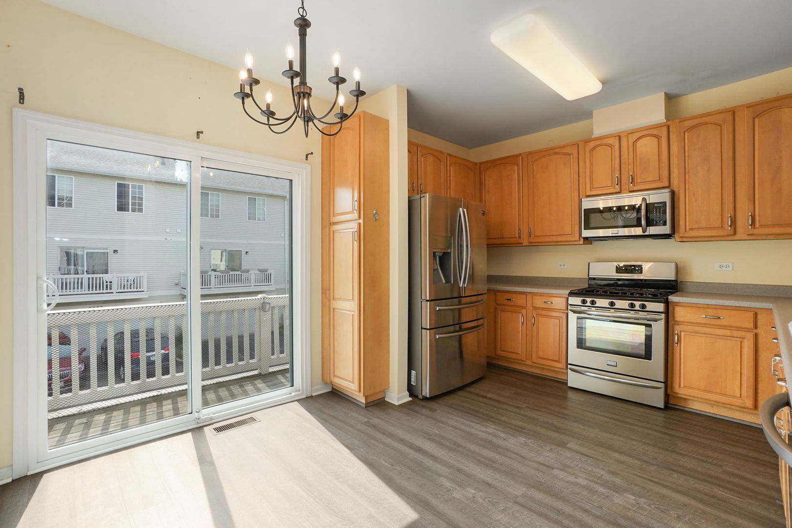 3446 Ravinia Circle Aurora, IL 60504 - Photo 8 of 25 a kitchen with stainless steel appliances a stove a refrigerator and a sink