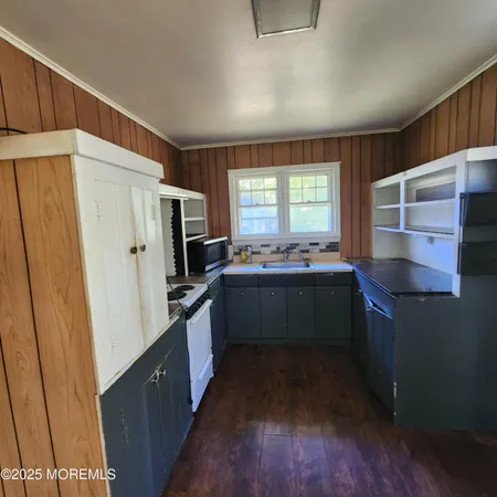 a kitchen with a sink stove and refrigerator