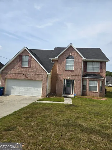 a front view of a house with a yard