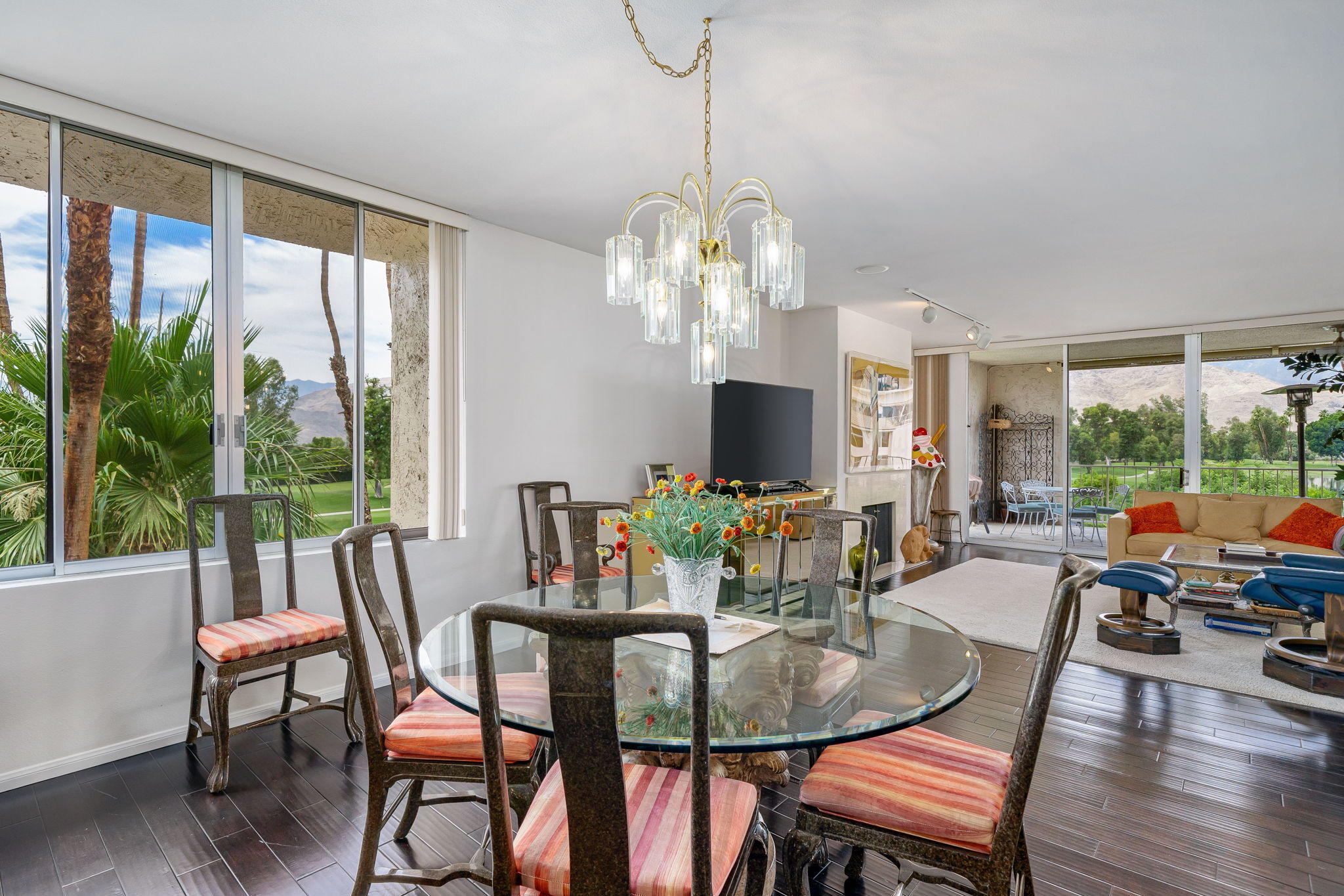 900 Island Drive, Unit 314 Rancho Mirage, CA 92270 - Photo 13 of 46 a view of a dining room with furniture large windows and wooden floor