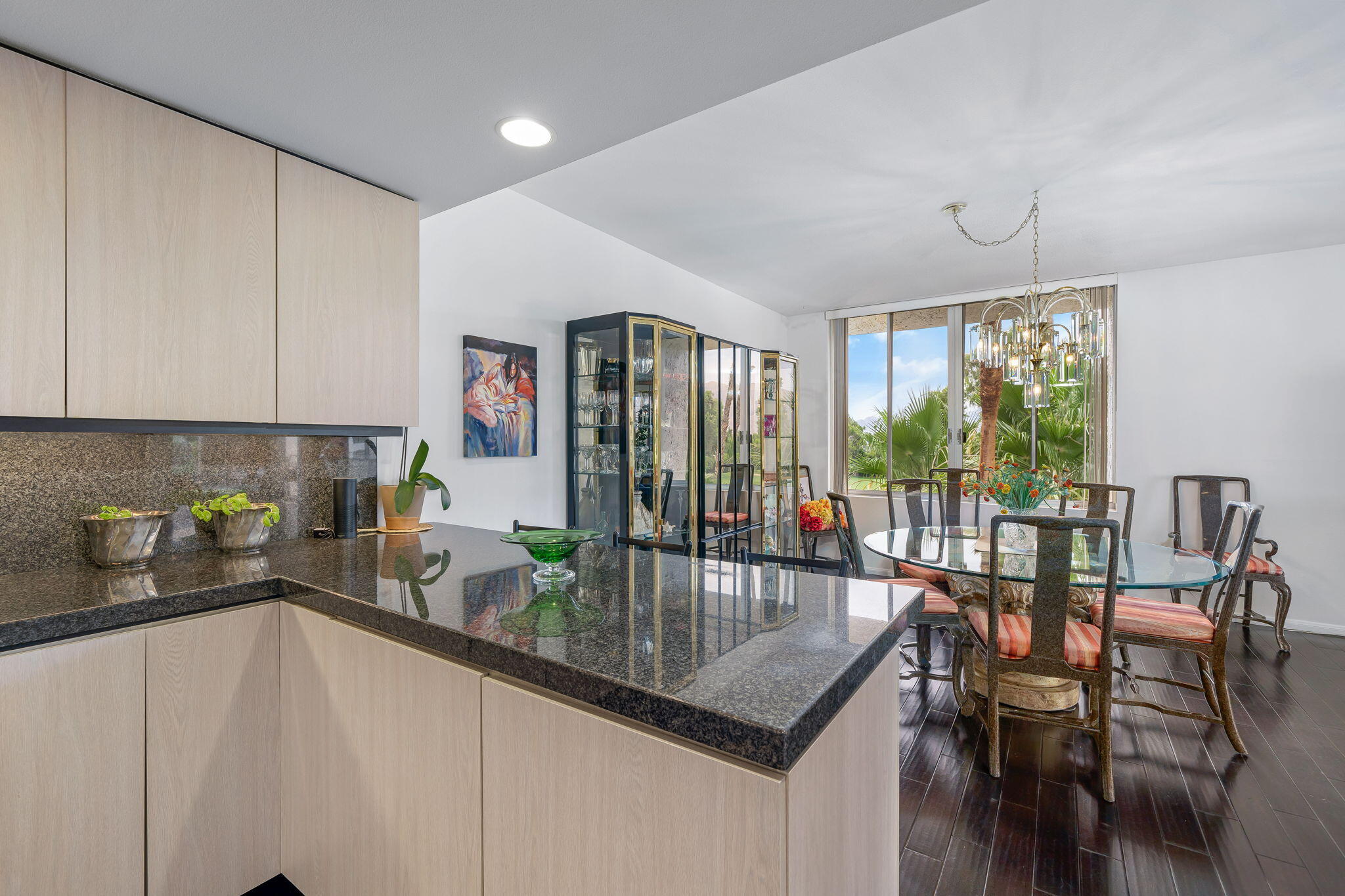 900 Island Drive, Unit 314 Rancho Mirage, CA 92270 - Photo 15 of 46 a kitchen with a table chairs stove and cabinets