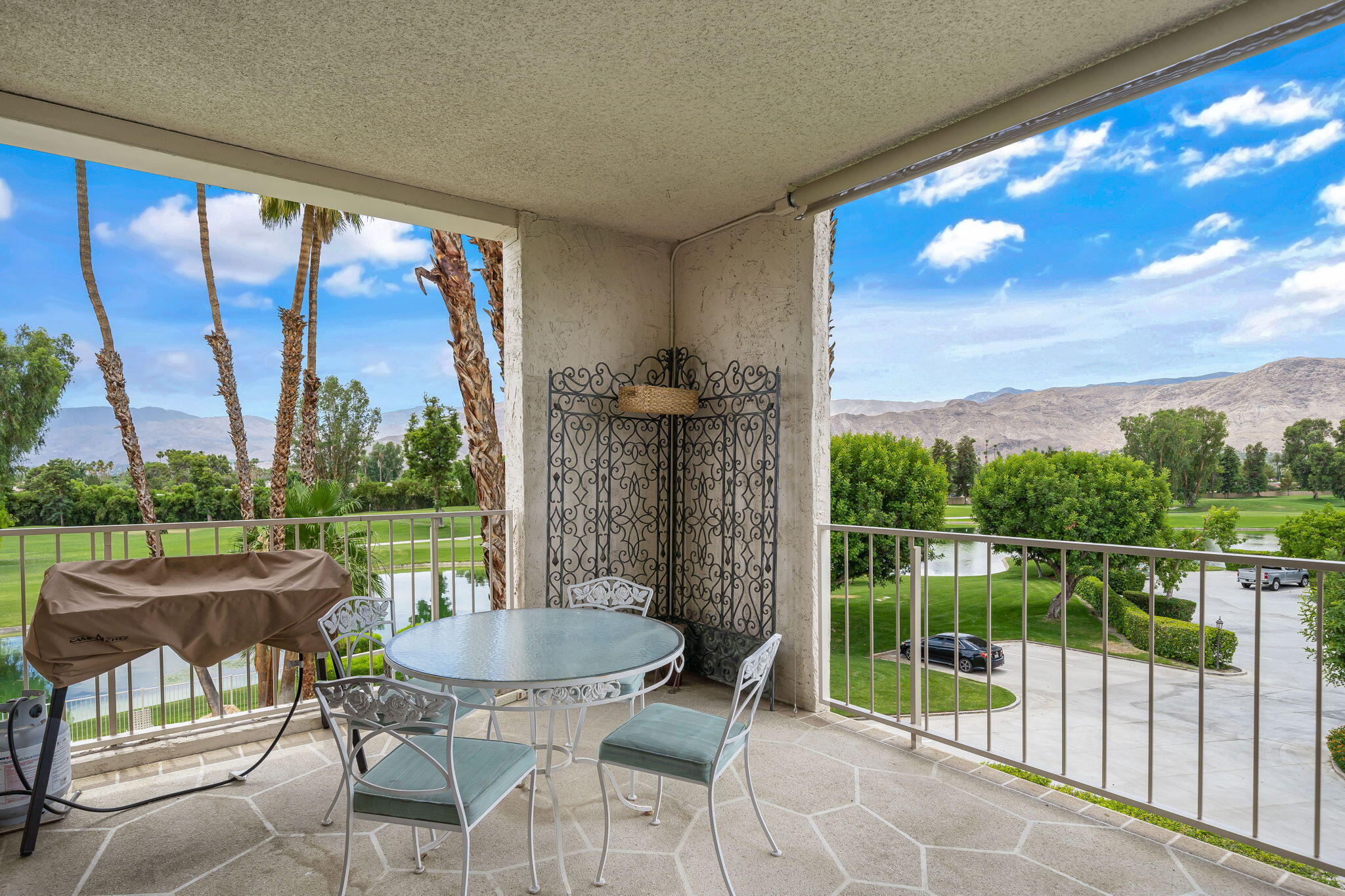900 Island Drive, Unit 314 Rancho Mirage, CA 92270 - Photo 20 of 46 a patio with glass top table and chairs