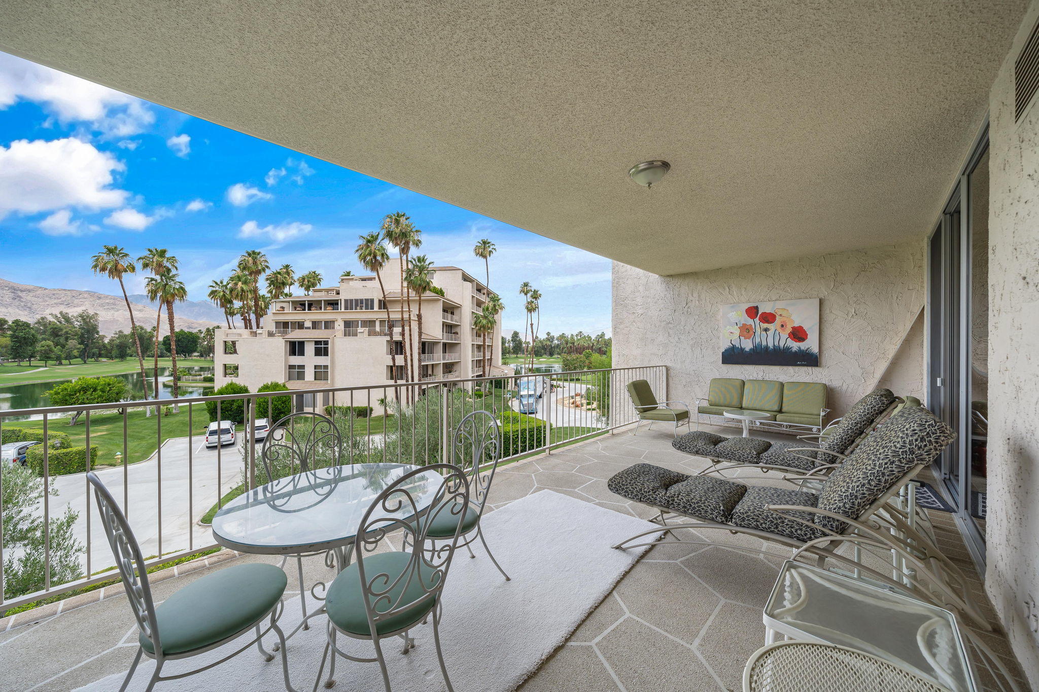 900 Island Drive, Unit 314 Rancho Mirage, CA 92270 - Photo 24 of 46 a balcony with furniture and a lake view