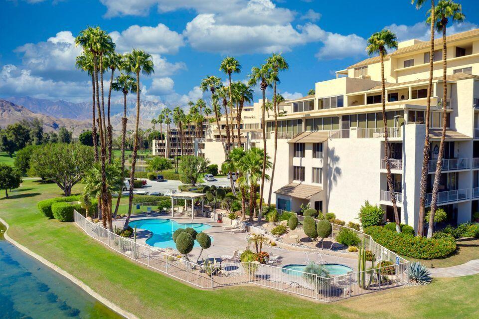900 Island Drive, Unit 314 Rancho Mirage, CA 92270 - Photo 34 of 46 a view of a swimming pool with a table and chairs
