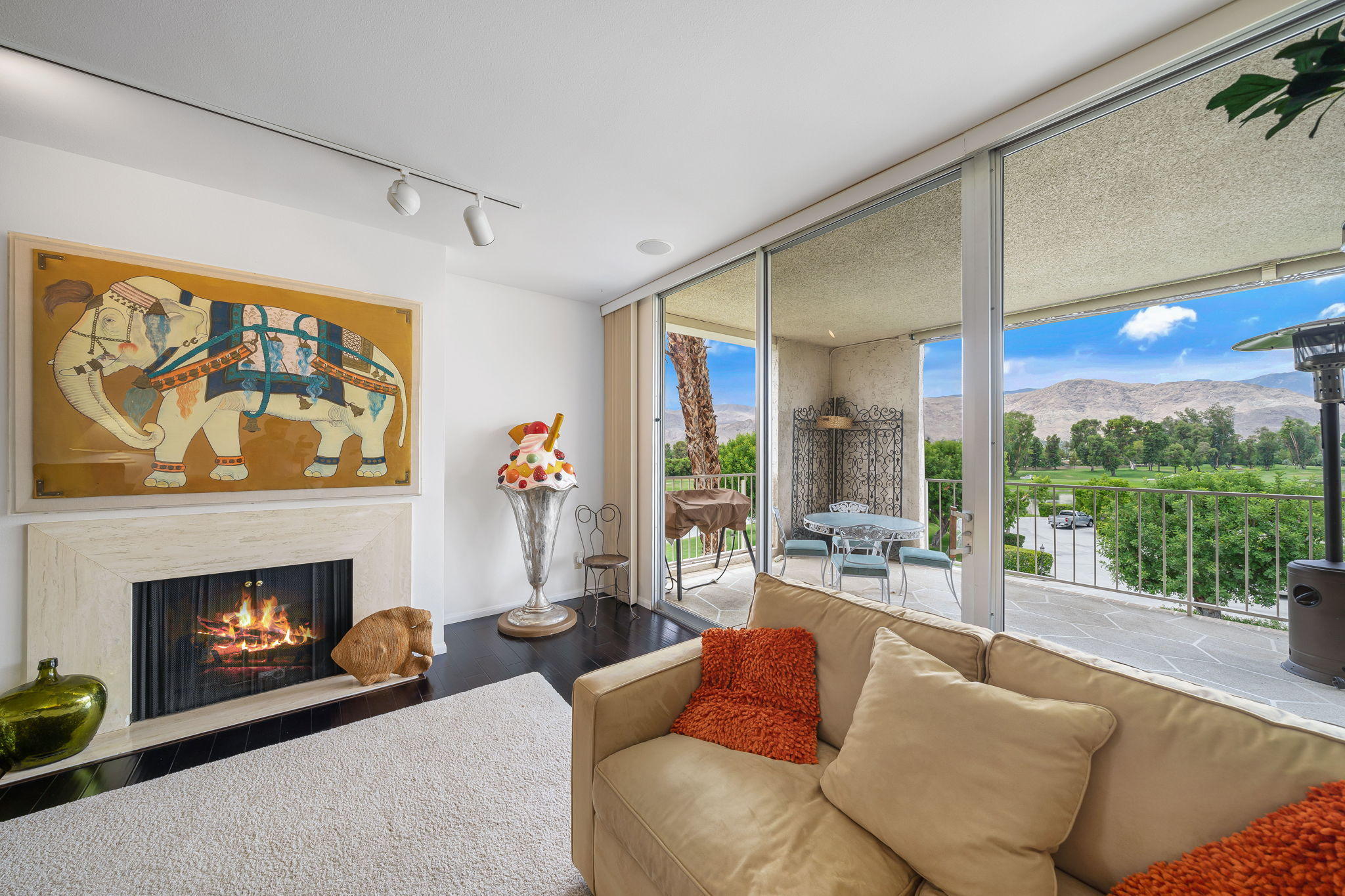 900 Island Drive, Unit 314 Rancho Mirage, CA 92270 - Photo 10 of 46 a living room with furniture a fireplace and a floor to ceiling window