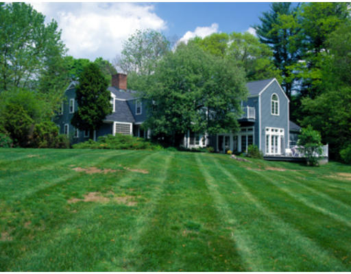42 Ripley Lane Weston, MA 02493 - Photo 1 of 7 a view of a house with a big yard and large trees
