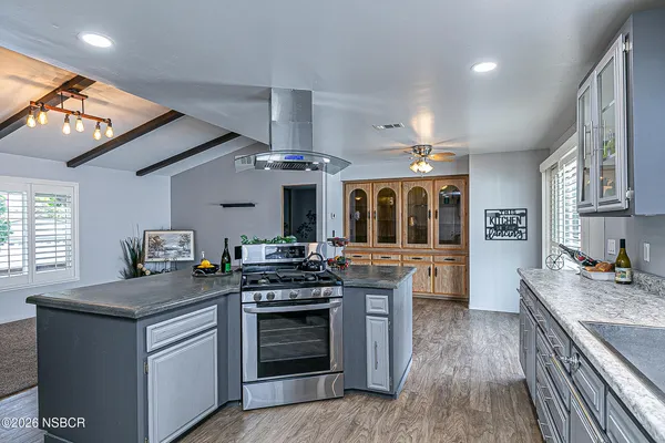 a kitchen with stainless steel appliances granite countertop a stove and a sink