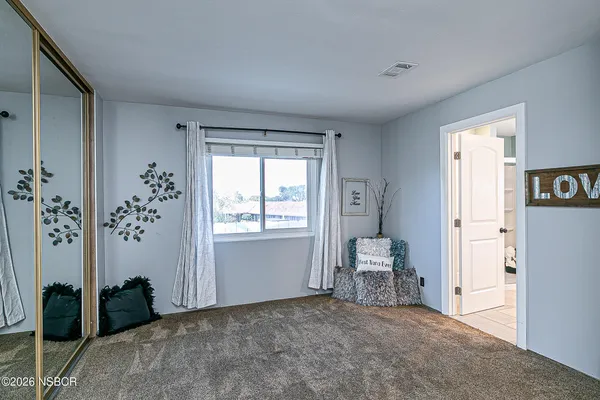a view of room with window and furniture