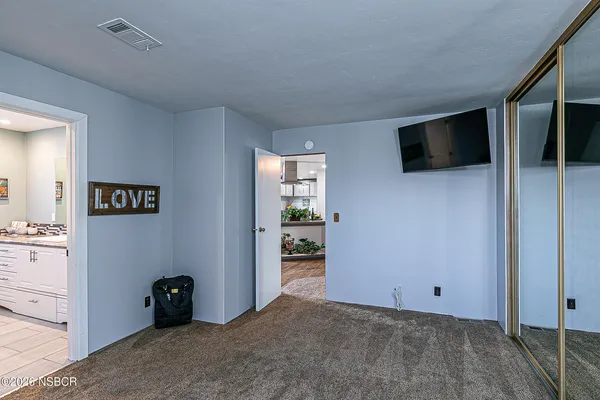 a view of a livingroom with an empty space and a window