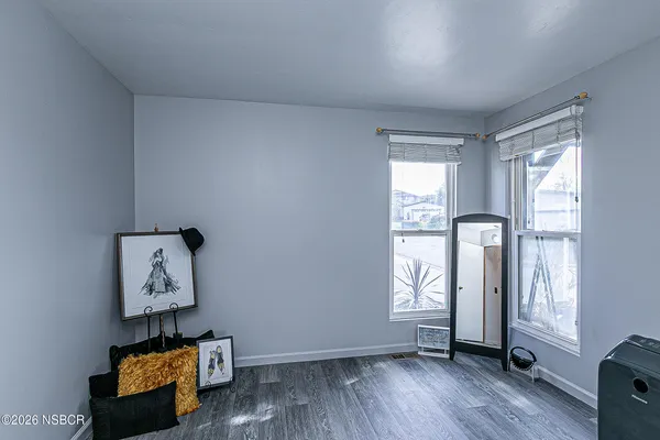 a view of room with window and wooden floor