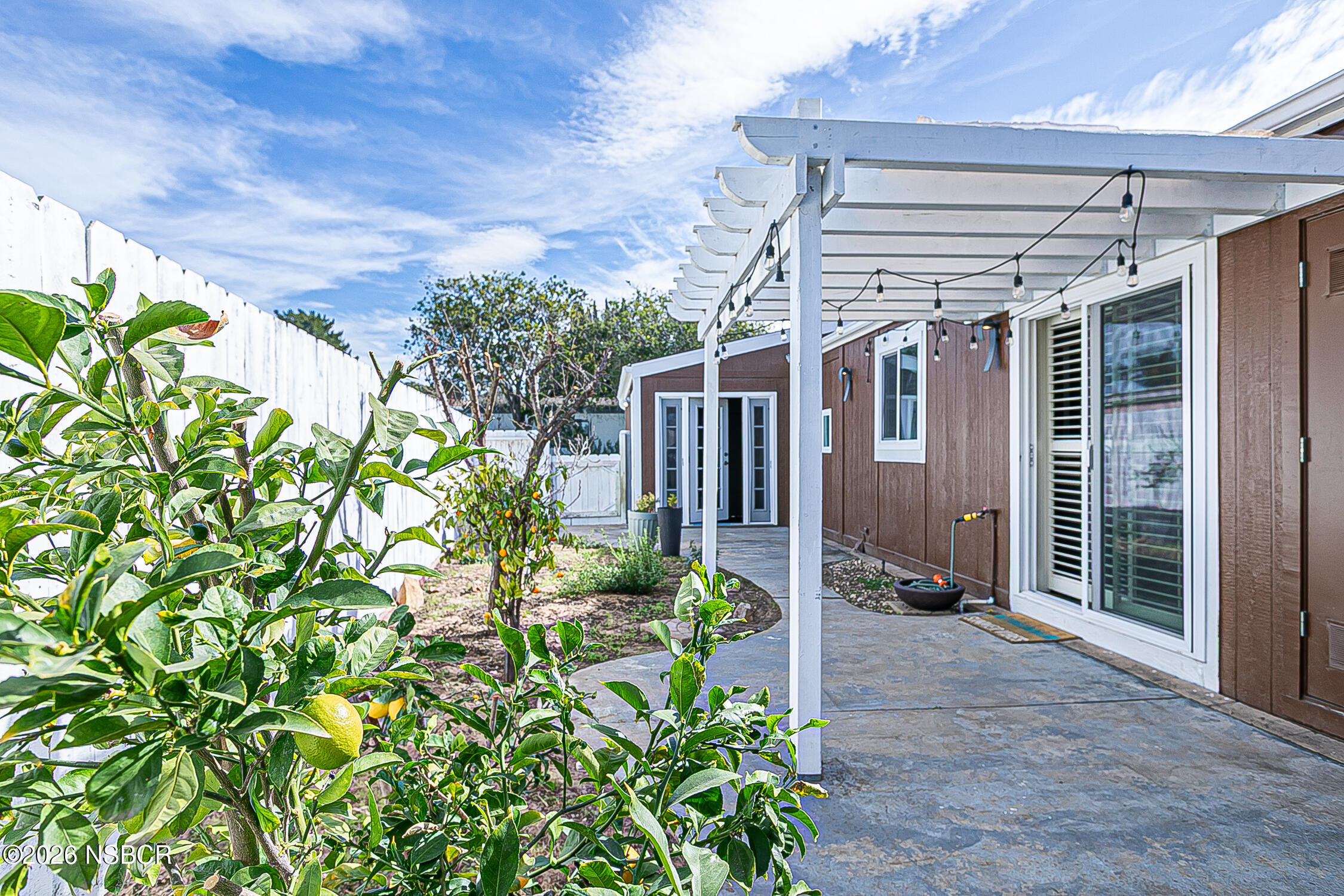 3985 Chatham Way Santa Maria, CA 93455 - Photo 21 of 22 a yellow house with flower garden in front of it