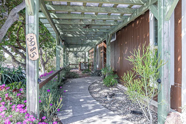 a view of a pathway of a house with wooden fence