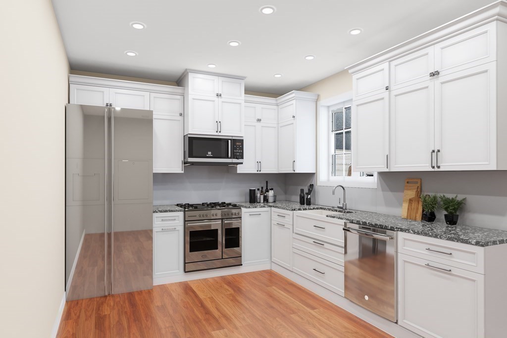 35 Fredonian Street, Unit K Shirley, MA 01464 - Photo 2 of 12 a kitchen with stainless steel appliances granite countertop a stove sink and cabinets