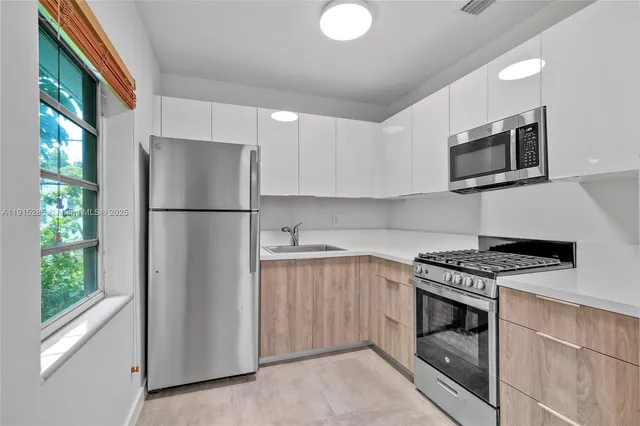 a kitchen with a refrigerator stove and microwave