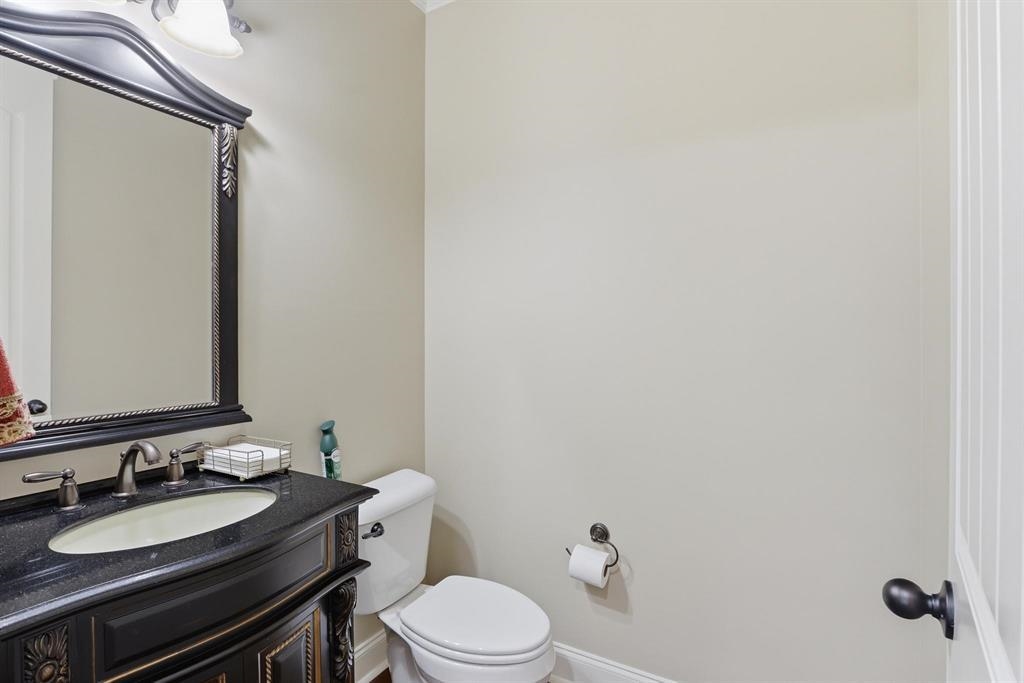 1301 Conser Street Collierville, TN 38017 - Photo 23 of 39 a bathroom with a granite countertop toilet sink and mirror
