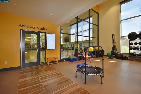 a living room with furniture a wooden floor and next to a window