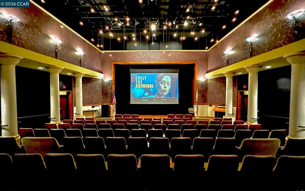 a room with furniture projector and screen