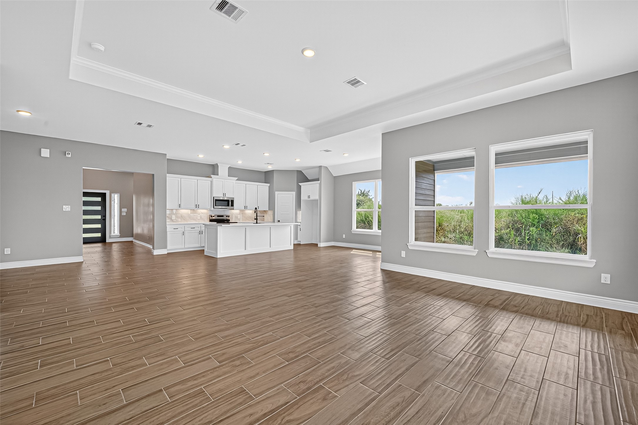 501 Oleander Street Prairie View, TX 77484 - Photo 15 of 48 a view of an empty room with a window and wooden floor