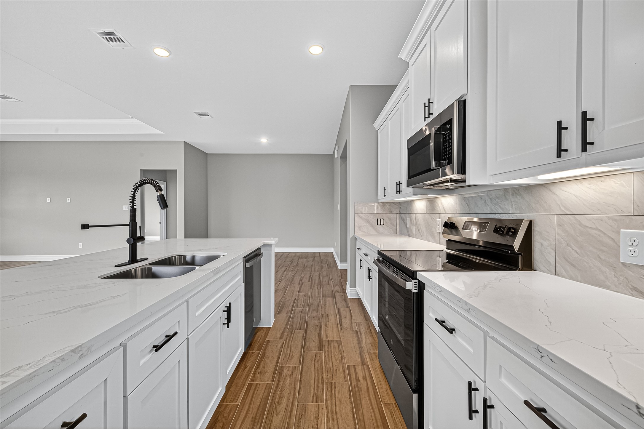 501 Oleander Street Prairie View, TX 77484 - Photo 24 of 48 a kitchen with stainless steel appliances granite countertop a sink stove and cabinets